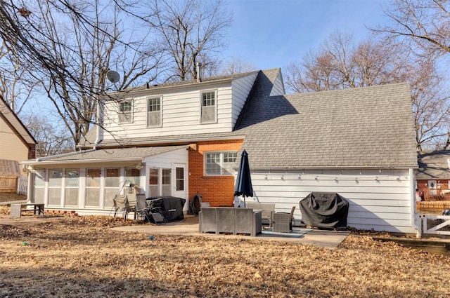 rear view of property featuring a patio area and a sunroom