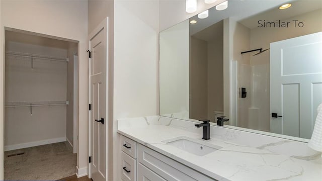 bathroom featuring vanity and a shower