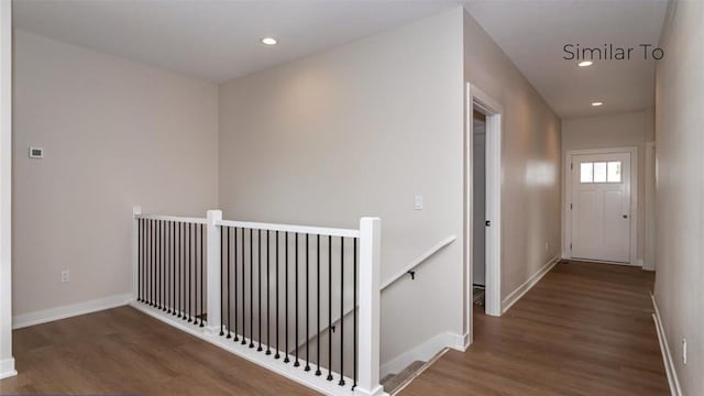 corridor with dark hardwood / wood-style flooring