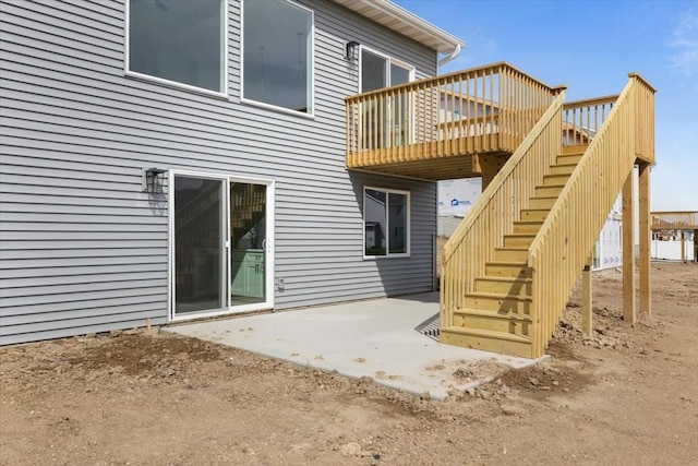 575 NW Prairie Rose Ln, Waukee, IA 50263 - back of property featuring a deck, stairs, and a patio