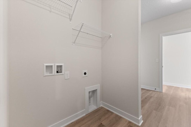 575 NW Prairie Rose Ln, Waukee, IA 50263 - clothes washing area with electric dryer hookup, wood finished floors, hookup for a washing machine, and baseboards