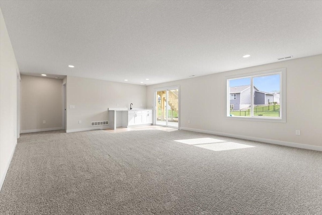 575 NW Prairie Rose Ln, Waukee, IA 50263 - carpeted spare room featuring recessed lighting, baseboards, and a sink