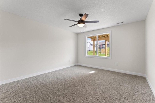 575 NW Prairie Rose Ln, Waukee, IA 50263 - empty room featuring carpet, baseboards, a ceiling fan, and a textured ceiling