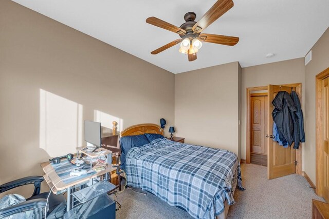 bedroom featuring light carpet and ceiling fan