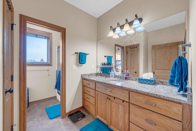 bathroom with tile patterned flooring and vanity