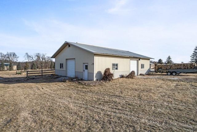 back of house with a garage and an outdoor structure