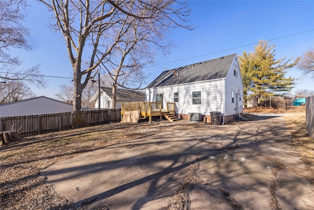 rear view of house featuring central AC and a deck