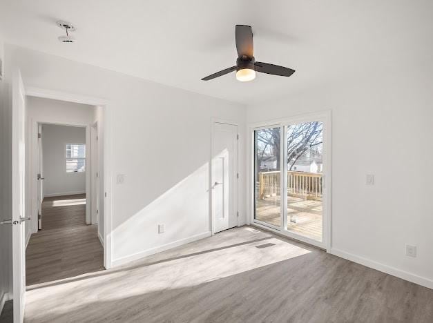 empty room featuring hardwood / wood-style flooring and ceiling fan