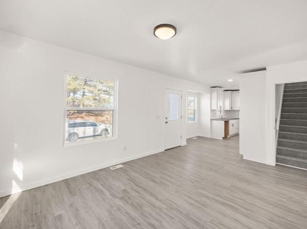 unfurnished living room with light hardwood / wood-style flooring