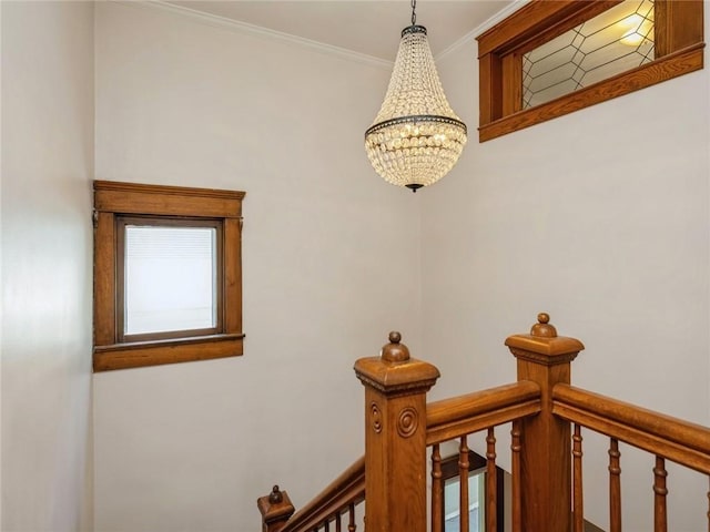 room details featuring ornamental molding and a notable chandelier