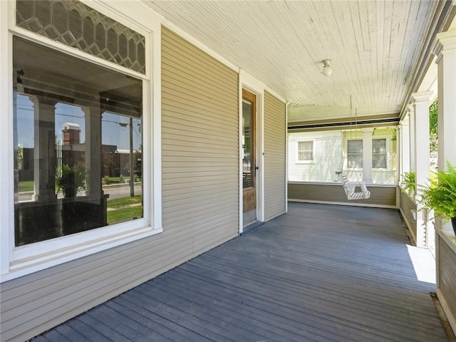 wooden terrace featuring covered porch