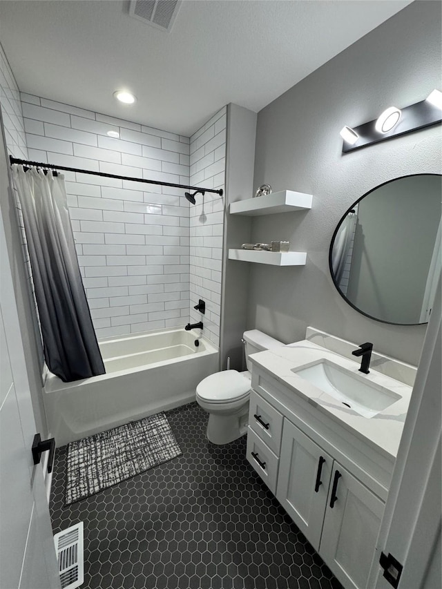 full bathroom with vanity, shower / tub combo, and toilet