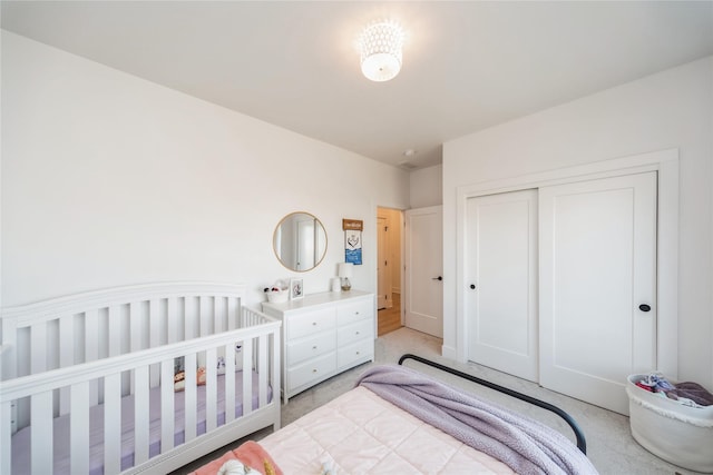 bedroom featuring light carpet and a closet