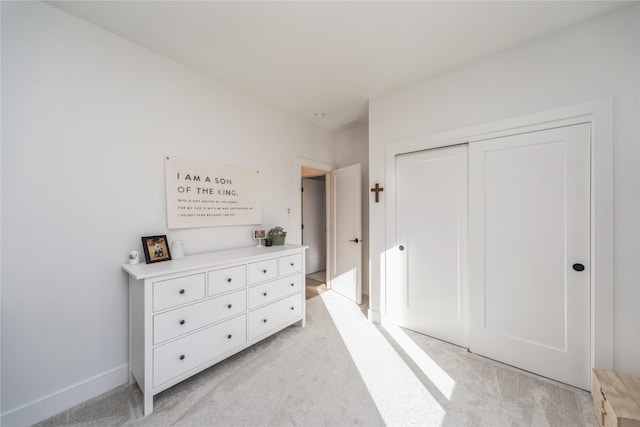 carpeted bedroom featuring a closet