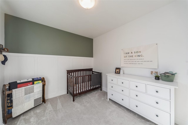 carpeted bedroom with a crib