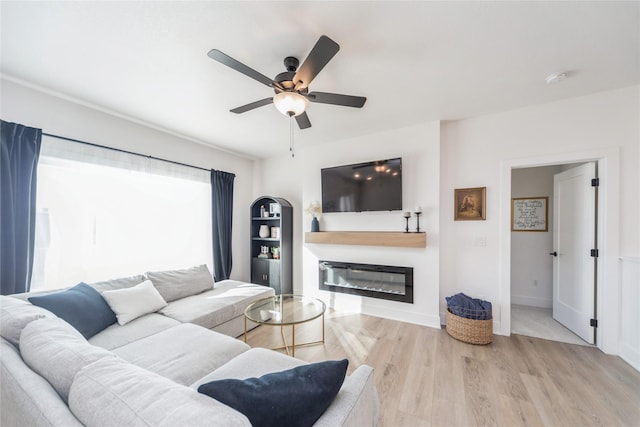 living room with ceiling fan and light wood-type flooring