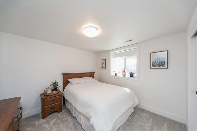 bedroom with light colored carpet