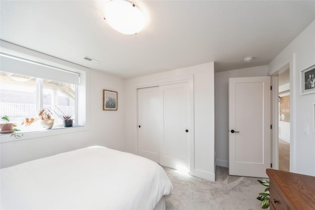 carpeted bedroom with a closet