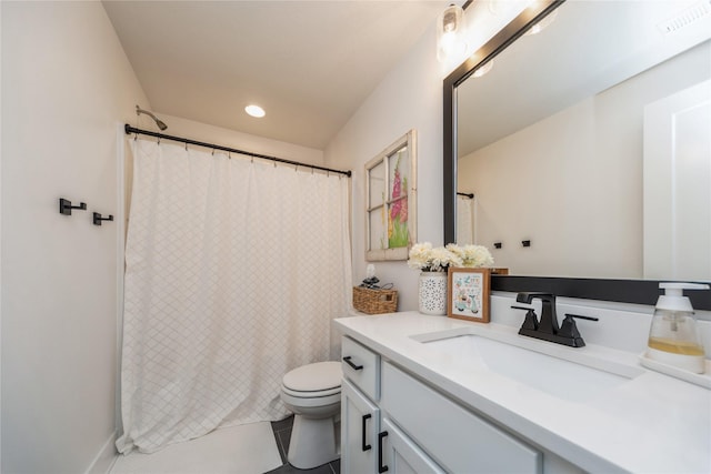 bathroom featuring tile patterned flooring, vanity, and toilet