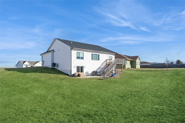 rear view of property with a yard