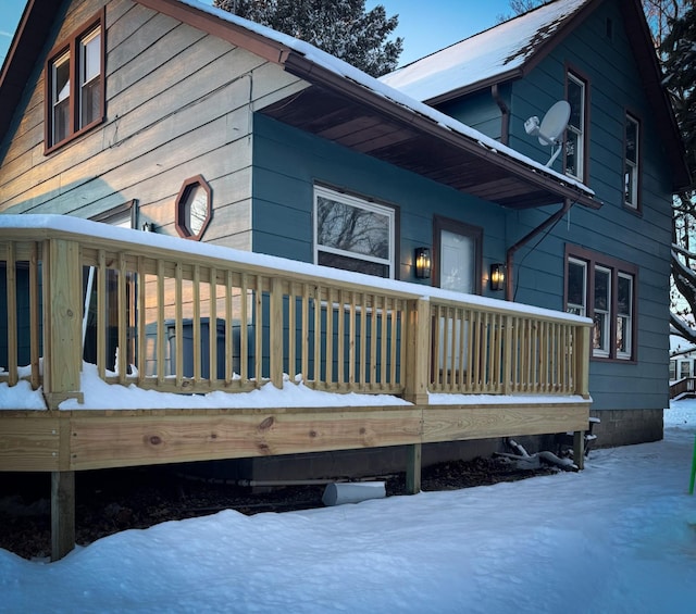 snow covered property featuring a deck