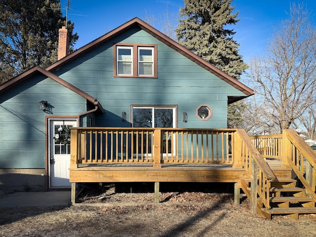 rear view of property with a wooden deck