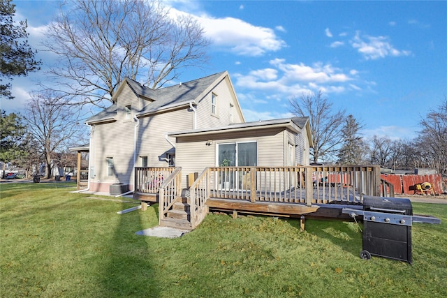 rear view of house featuring central AC unit, a yard, and a deck