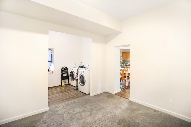 clothes washing area featuring washing machine and dryer and carpet flooring