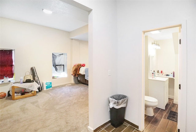 interior space featuring vanity and toilet