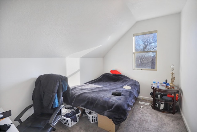 carpeted bedroom featuring vaulted ceiling and a textured ceiling