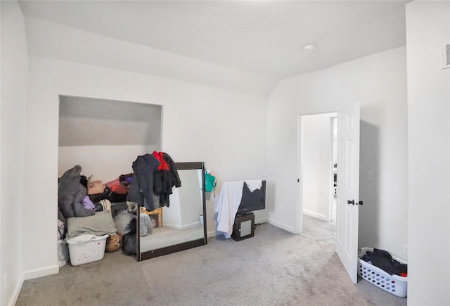 miscellaneous room with light colored carpet and lofted ceiling