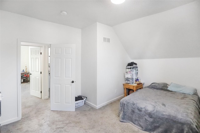 carpeted bedroom with lofted ceiling