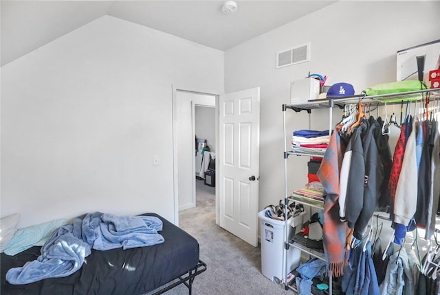 carpeted bedroom featuring vaulted ceiling