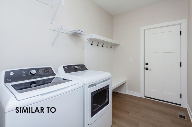 laundry area with hardwood / wood-style floors and washer and clothes dryer