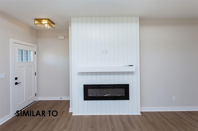 foyer entrance featuring hardwood / wood-style floors and a fireplace