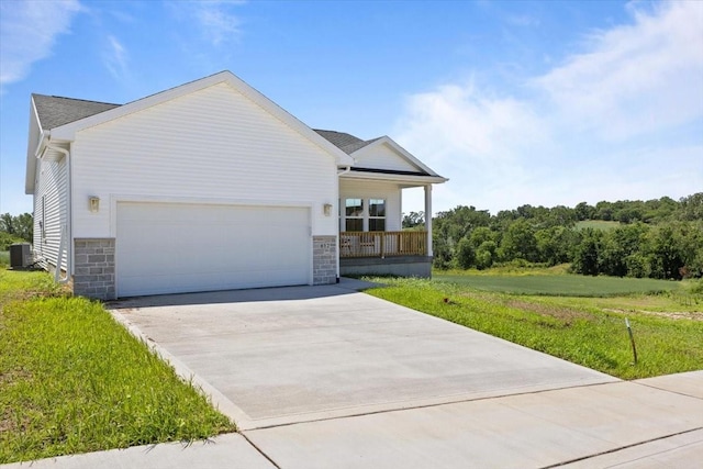 612 W Walnut Pl, Norwalk, IA 50211 - ranch-style house featuring an attached garage, driveway, a porch, and stone siding