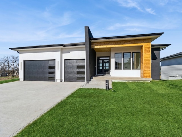 contemporary home with a garage and a front lawn