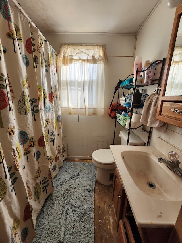 bathroom featuring toilet, hardwood / wood-style floors, vanity, and a shower with curtain