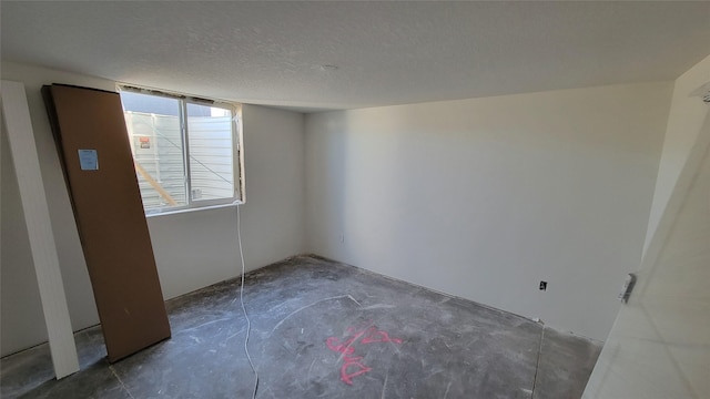 spare room featuring a textured ceiling