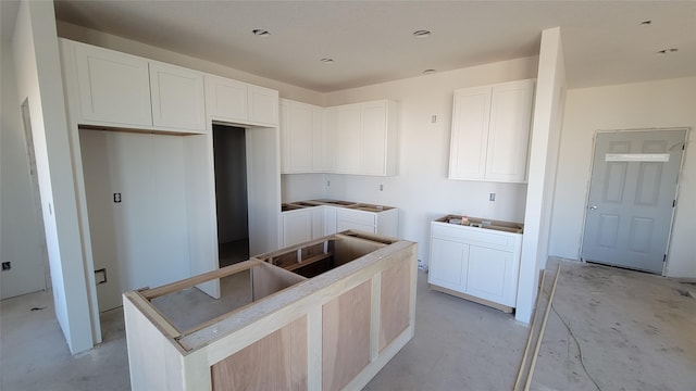 kitchen featuring white cabinetry, light brown cabinets, and a kitchen island