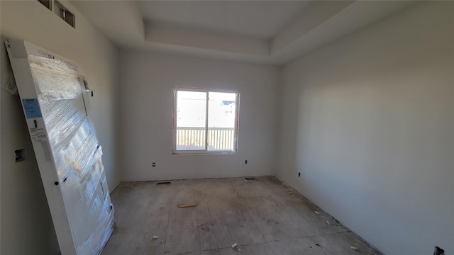 empty room featuring a tray ceiling