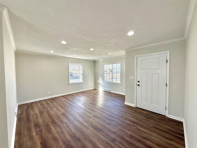 interior space featuring ornamental molding, dark hardwood / wood-style floors, and a textured ceiling