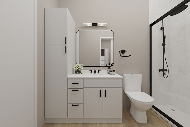 bathroom with vanity, hardwood / wood-style floors, toilet, and tiled shower