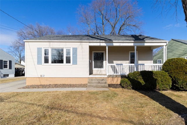 bungalow-style home with a front yard and covered porch