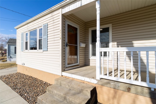 view of exterior entry with a porch