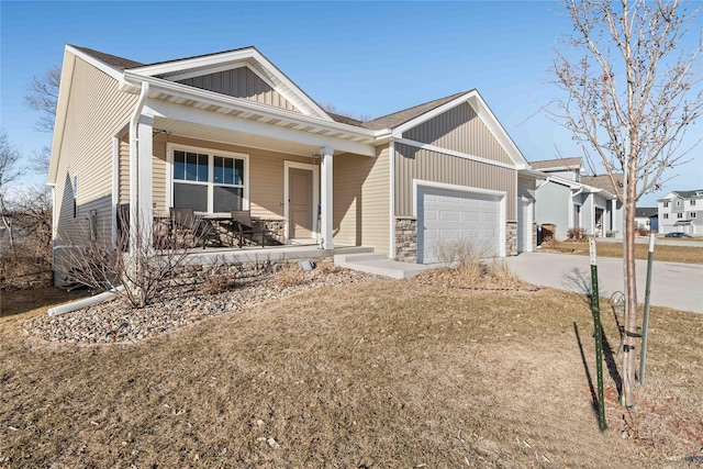 view of front of home with a porch, a garage, and a front lawn