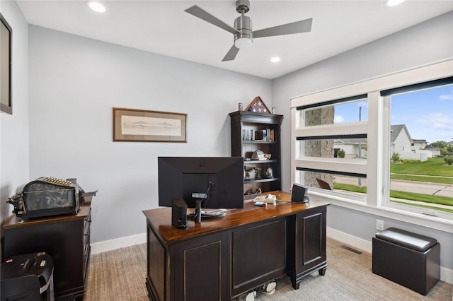 office with light carpet and ceiling fan