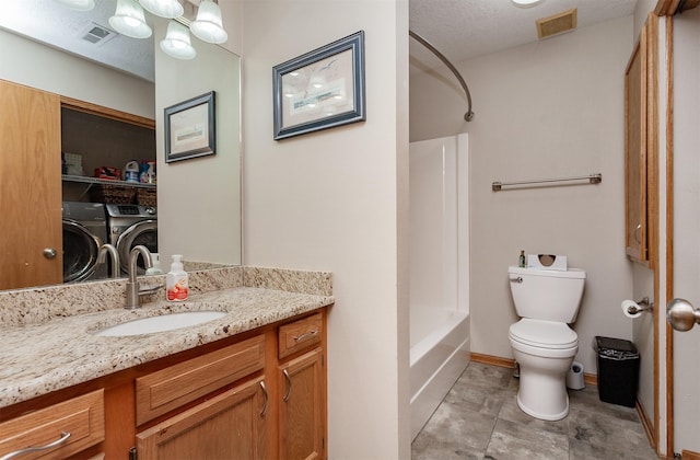 full bathroom featuring toilet, washer and dryer, a textured ceiling, vanity, and shower / washtub combination