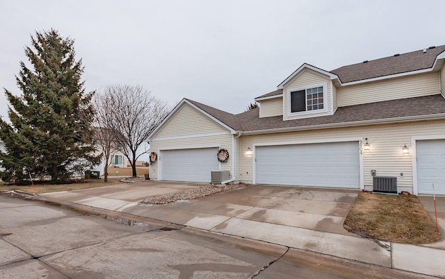 view of front of house featuring a garage and central air condition unit