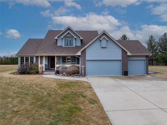 view of front of house featuring a garage, a front lawn, and covered porch